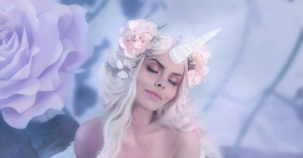 How to Be a Unicorn - A Woman with a Unicorn Horn and Roses