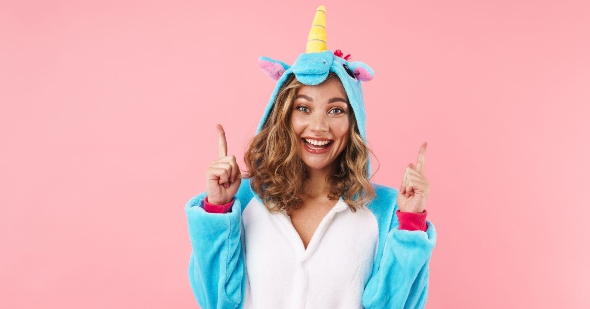 What Is My Unicorn Name - An Excited Woman in a Unicorn Onesie
